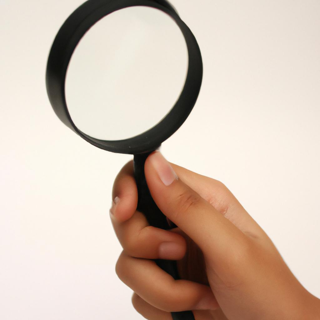 Person holding a magnifying glass